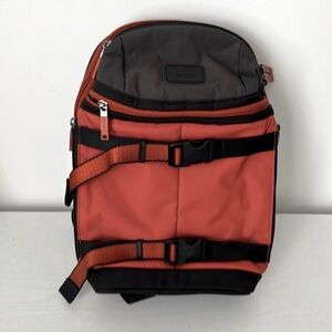 Tumi sling back bag in orange